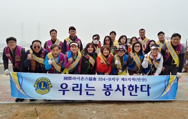 ​안산 국제라이온스협회 354-B 지구 9지역 회원들이 환경정화 봉사를 마친 후 기념촬영을 하고 있다.