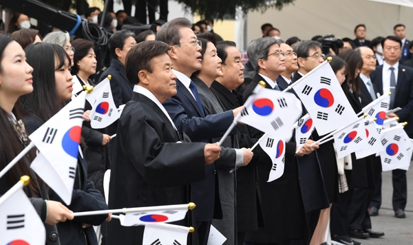 문재인 대통령이 1일 서울 종로구 배화여고에서 열린 3.1절 기념식에서 참석자와 함께 태극기를 흔들며 3.1절 노래를 부르고 있다.